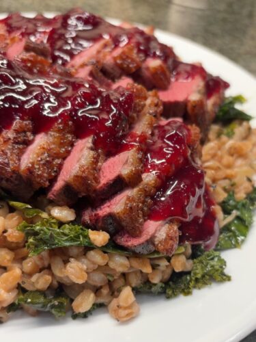 Seared duck breast with cherry gastrique and farro